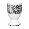 scale in ink design around white fine bone china egg cup in 22 carat detailing