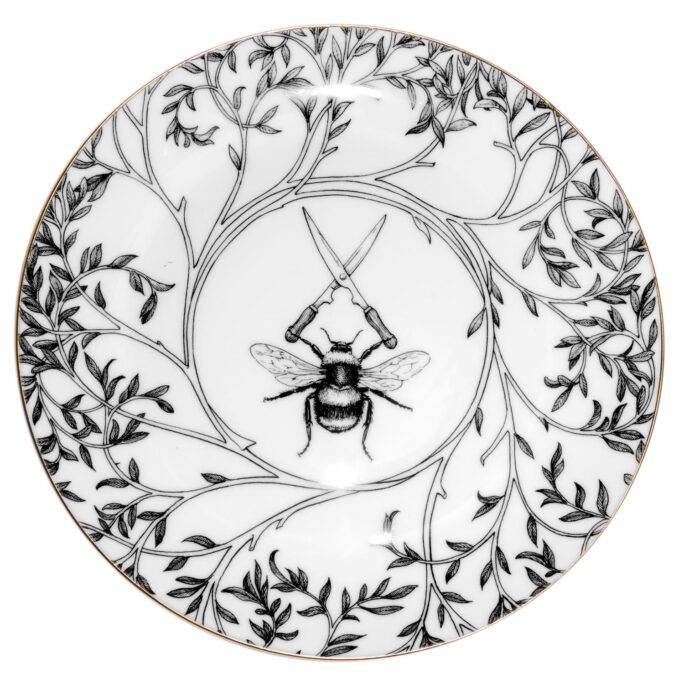 Bumble bee holding shears edged with leafy branches in ink design on white fine bone china plate